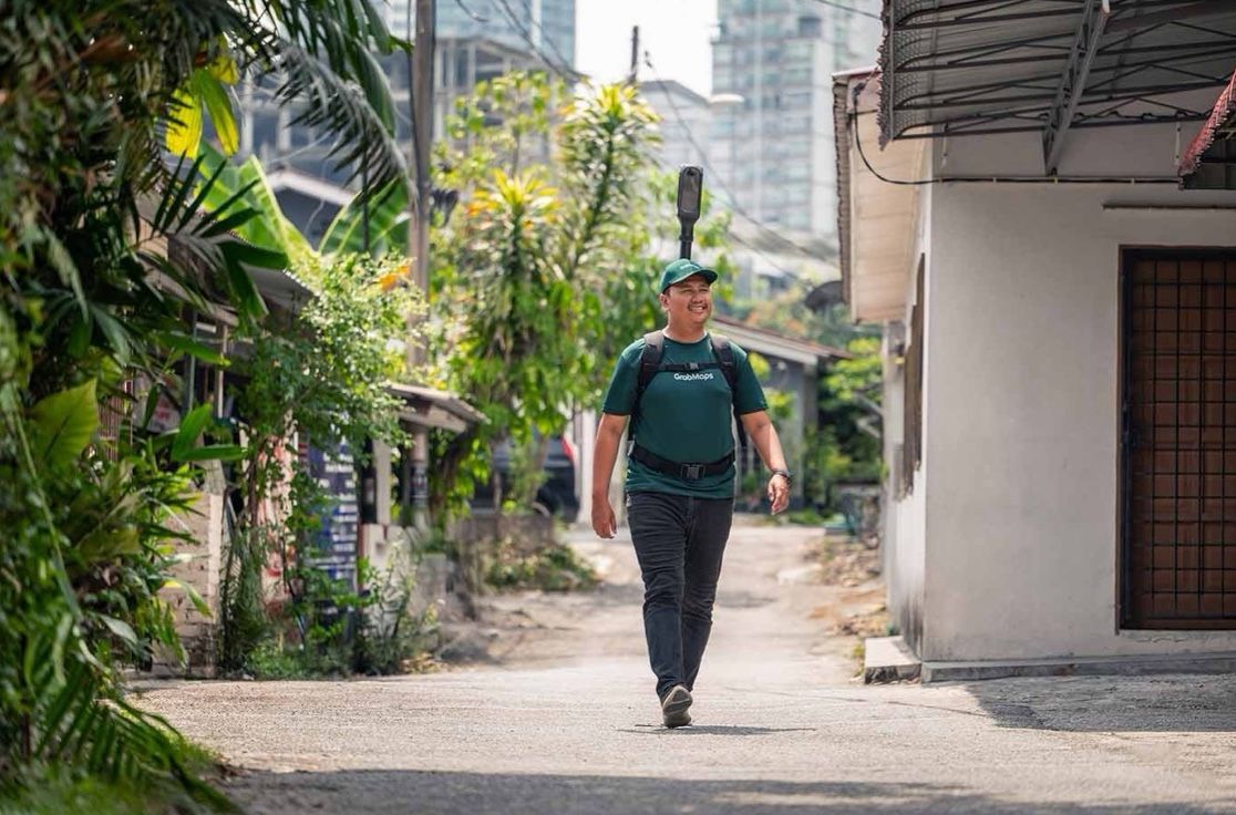 A mapper walking down a quiet residential lane