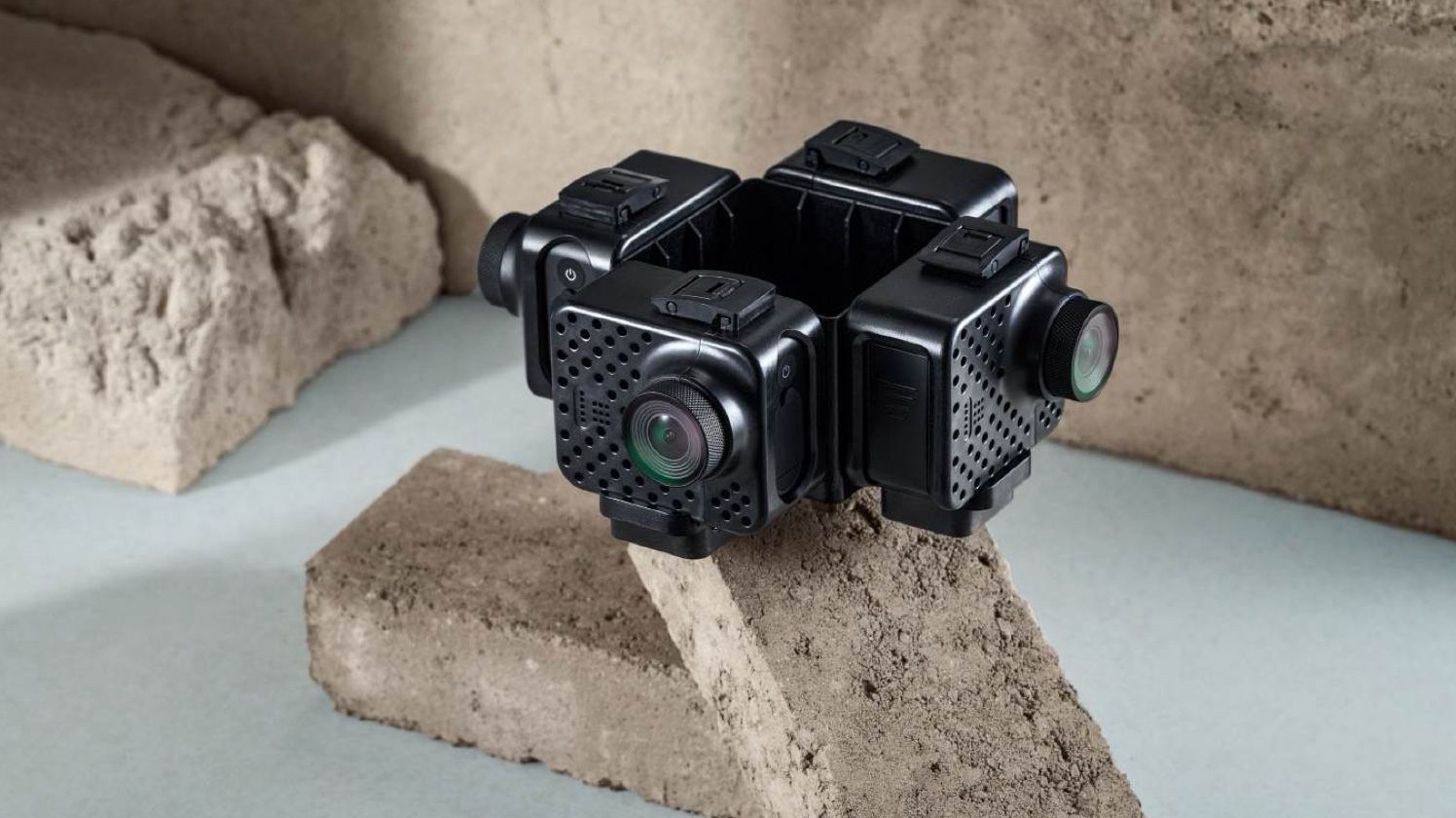 KartaCam 2nd edition, a four-lens cube, resting on angled stone bricks