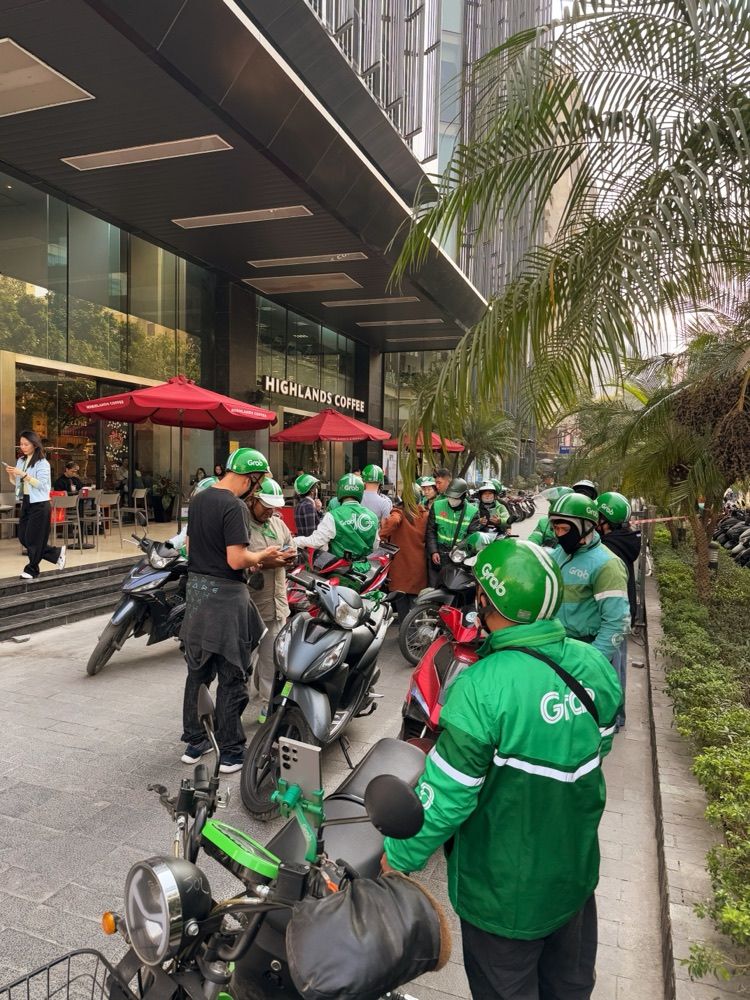 Grab driver-partners gathered on their bikes