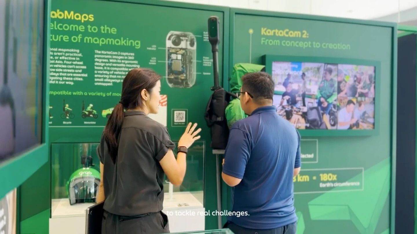 Visitors at the KartaCam 2 wall in the GrabMaps room