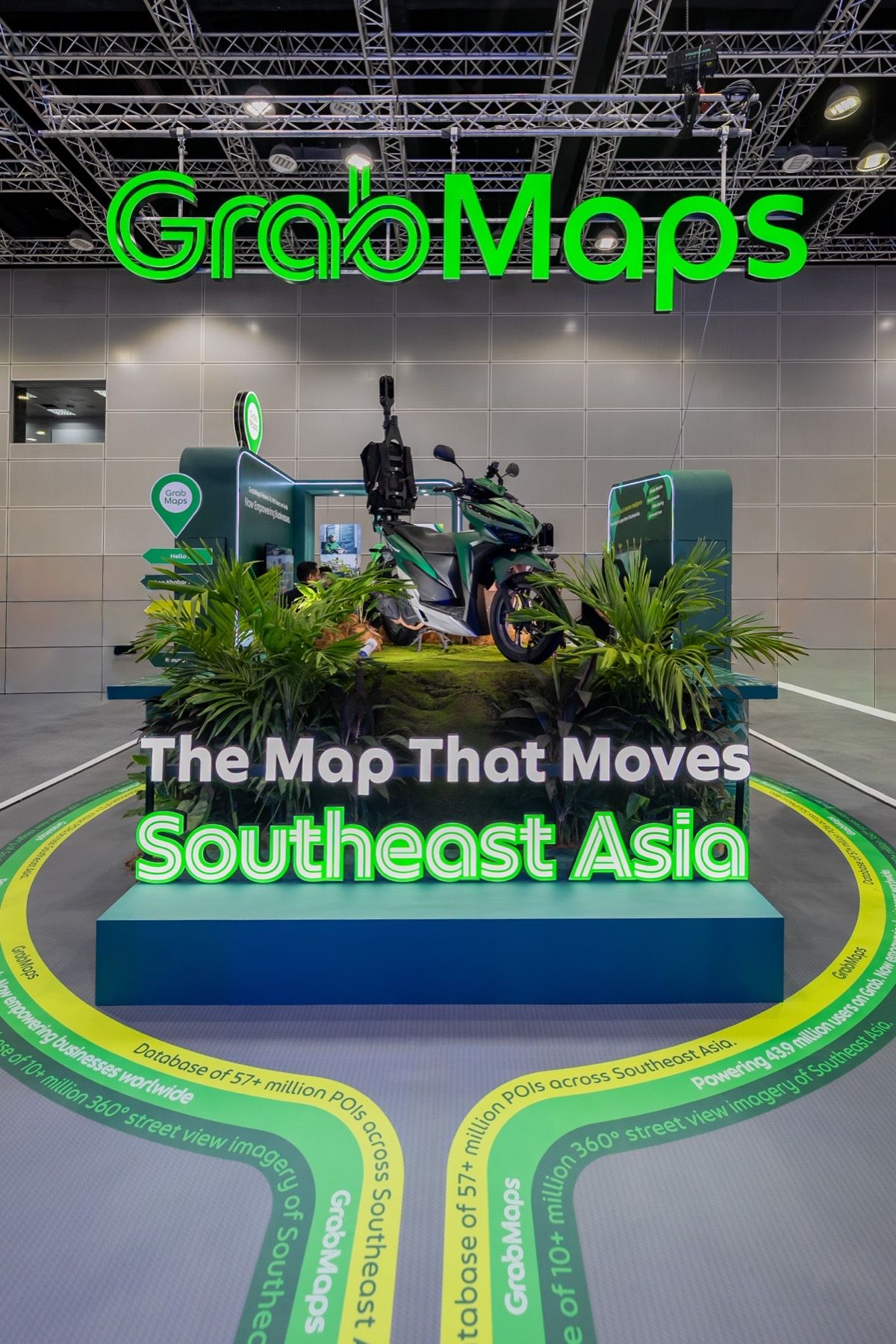 The booth’s GrabMaps sign above the bike centrepiece