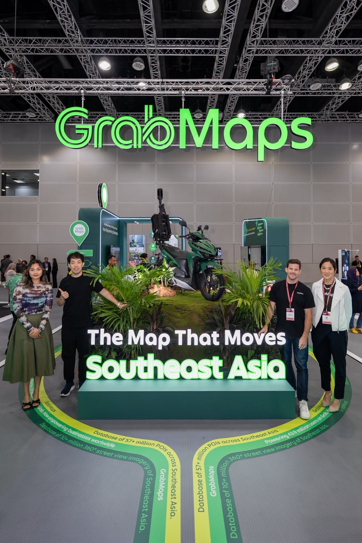 Two team members on each side of the booth under the GrabMaps sign